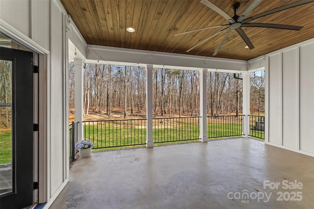 unfurnished sunroom featuring a ceiling fan