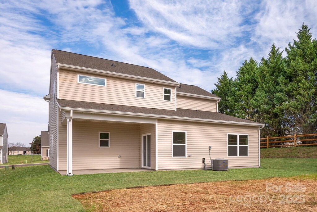 rear view of property with a patio, a yard, and fence