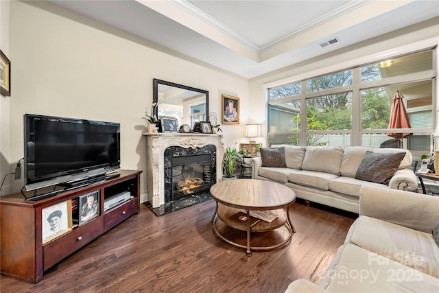 7909 Parknoll Dr, Huntersville, NC 28078 - living area with wood finished floors, visible vents, a premium fireplace, a tray ceiling, and ornamental molding
