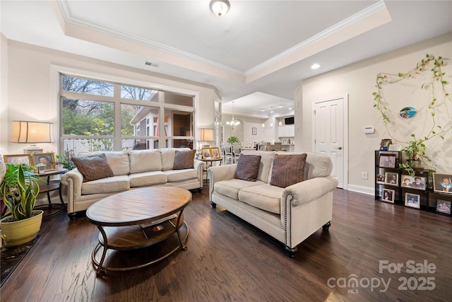 7909 Parknoll Dr, Huntersville, NC 28078 - living room with a tray ceiling, dark wood-style flooring, and crown molding