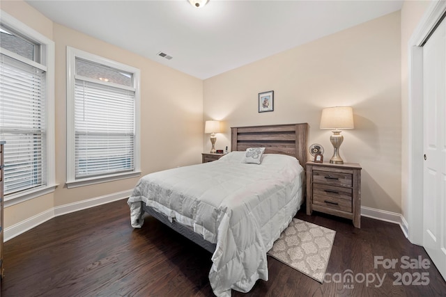 7909 Parknoll Dr, Huntersville, NC 28078 - bedroom with visible vents, baseboards, a closet, and dark wood-style floors