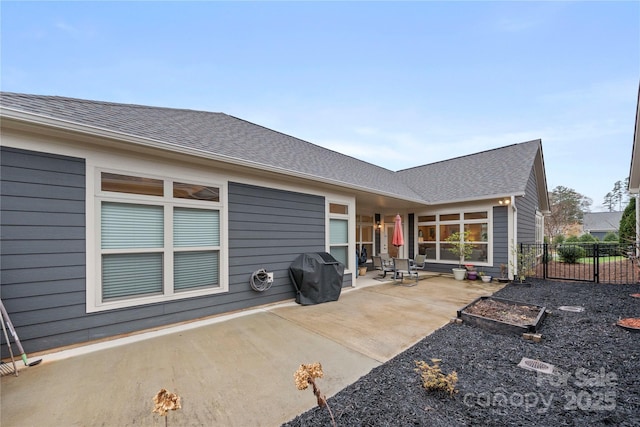 7909 Parknoll Dr, Huntersville, NC 28078 - back of house featuring a garden, a patio, a shingled roof, and fence