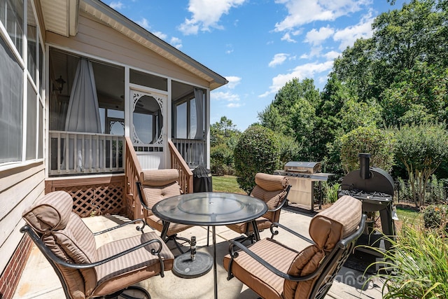 615 Vega St NW, Concord, NC 28027 - view of patio / terrace with a sunroom, outdoor dining space, and grilling area