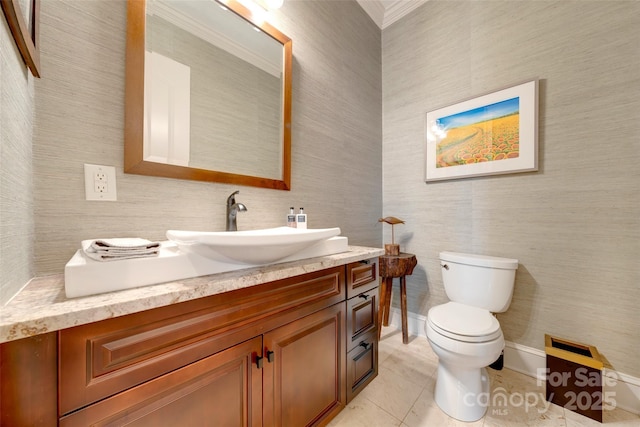 bathroom with tile patterned floors, crown molding, toilet, and vanity