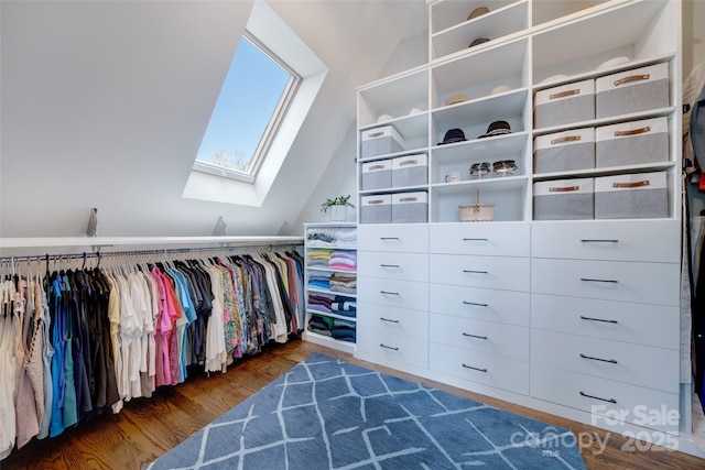 spacious closet with lofted ceiling with skylight and wood finished floors