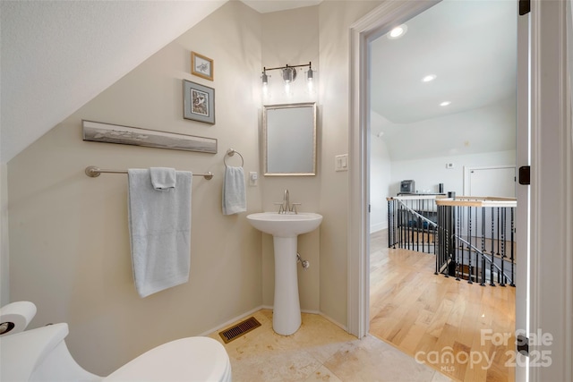 bathroom with toilet, wood finished floors, baseboards, visible vents, and recessed lighting