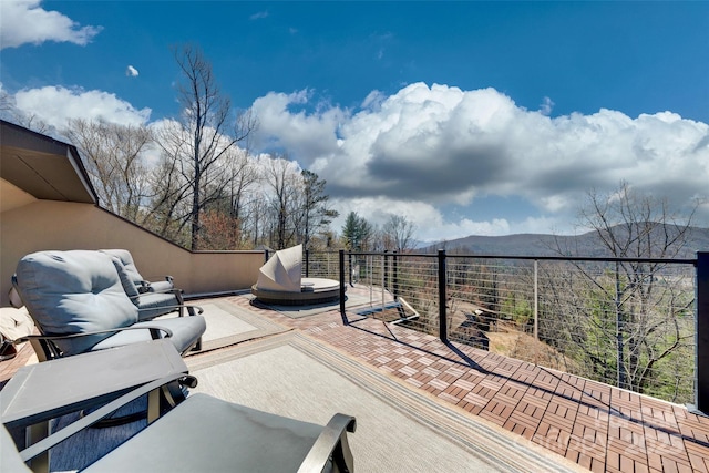 view of patio with a balcony and a mountain view