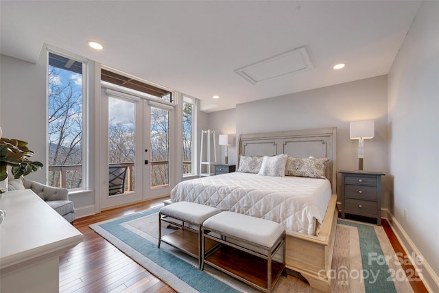bedroom featuring recessed lighting, attic access, access to exterior, hardwood / wood-style floors, and french doors