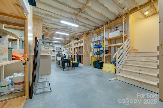 unfinished below grade area featuring stairs