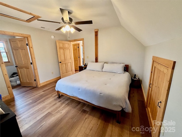 522 Woodgate Dr, Bostic, NC 28018 - bedroom featuring wood finished floors, vaulted ceiling, ceiling fan, and baseboards