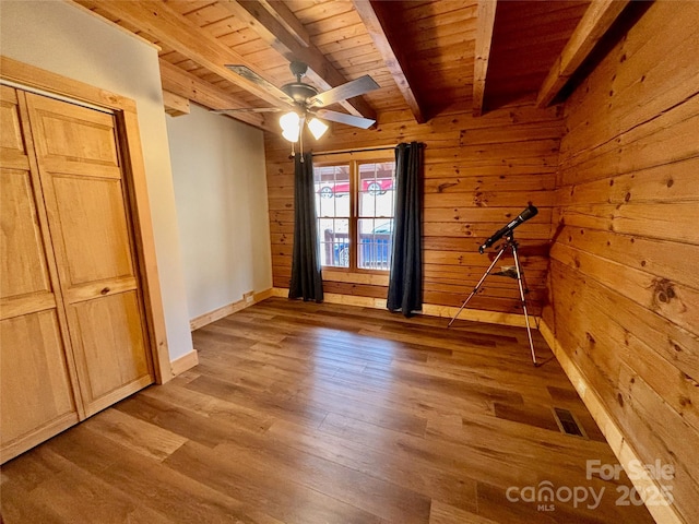 522 Woodgate Dr, Bostic, NC 28018 - unfurnished bedroom featuring wood ceiling, beamed ceiling, wood finished floors, baseboards, and wood walls