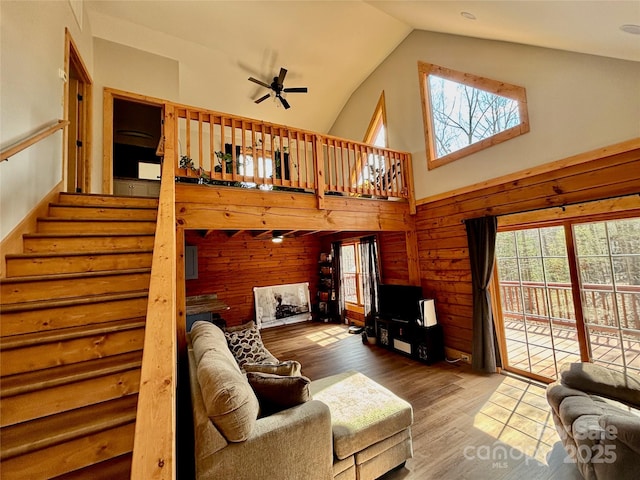 522 Woodgate Dr, Bostic, NC 28018 - living area featuring high vaulted ceiling, wood finished floors, stairway, a ceiling fan, and wood walls