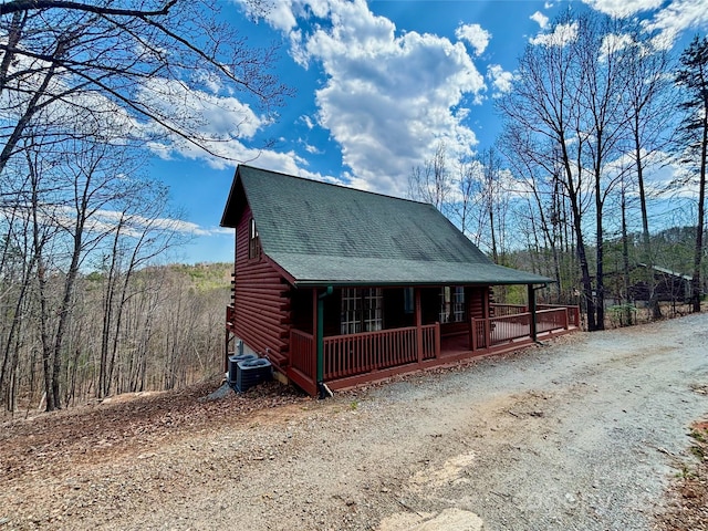 522 Woodgate Dr, Bostic, NC 28018 - view of front of home with a porch, log exterior, cooling unit, a shingled roof, and driveway