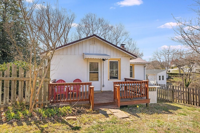 323 Emma Rd, Asheville, NC 28806 - back of property featuring a chimney, fence, and a wooden deck