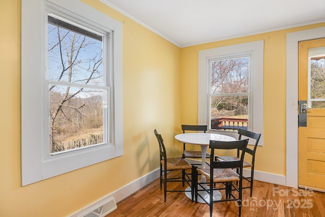 323 Emma Rd, Asheville, NC 28806 - dining space featuring baseboards, wood finished floors, and ornamental molding