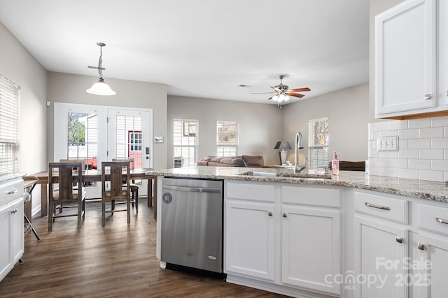 kitchen with a wealth of natural light, a sink, stainless steel dishwasher, a peninsula, and ceiling fan