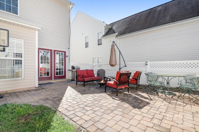 view of patio / terrace featuring a grill, an outdoor living space with a fire pit, and fence