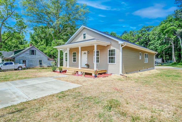 view of front facade with a porch, a front lawn, and crawl space