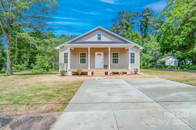 bungalow-style home with a porch and a front yard