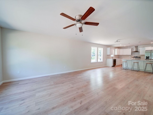 unfurnished living room with baseboards, light wood-style floors, recessed lighting, and ceiling fan