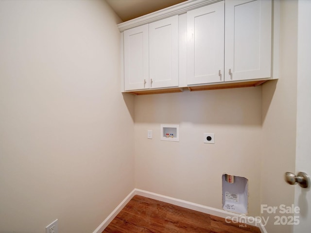 laundry room featuring hookup for an electric dryer, washer hookup, baseboards, cabinet space, and wood finished floors