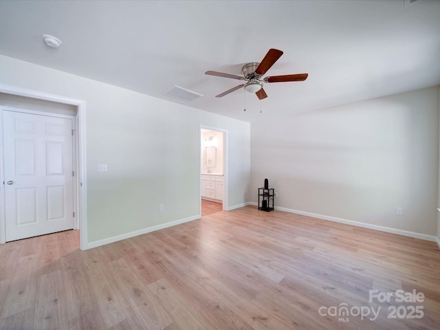 spare room featuring a ceiling fan, light wood-style flooring, baseboards, and a smoke detector
