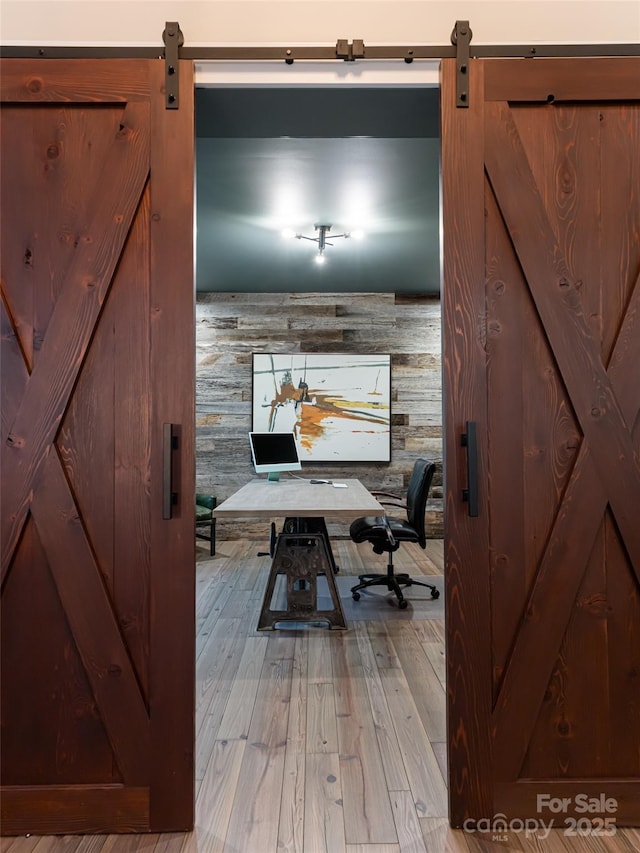 office space featuring a barn door and wood finished floors