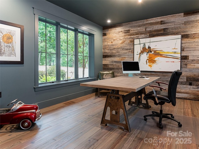 office space with wooden walls and wood finished floors