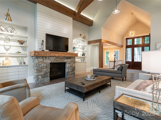 living room with built in features, wood finished floors, high vaulted ceiling, beam ceiling, and a fireplace
