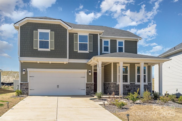 view of front of home with a garage, a porch, stone siding, and concrete driveway