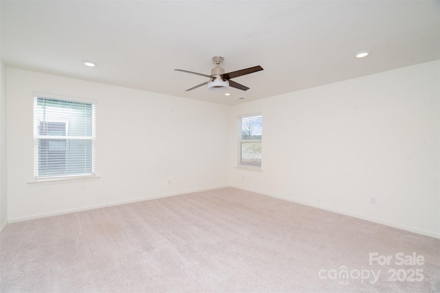 carpeted spare room featuring recessed lighting, baseboards, and ceiling fan