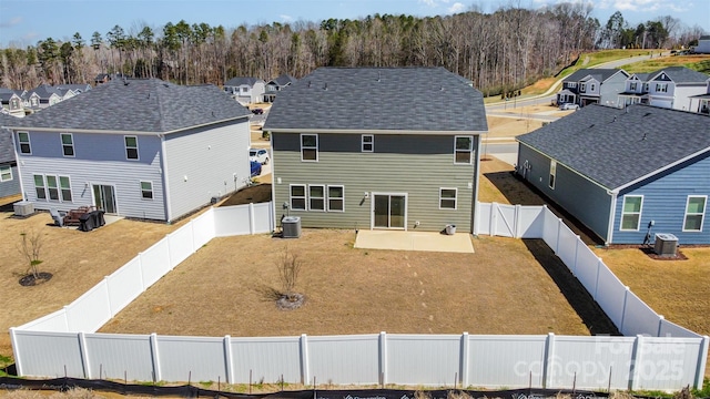 back of house with a patio, a residential view, central air condition unit, and a fenced backyard