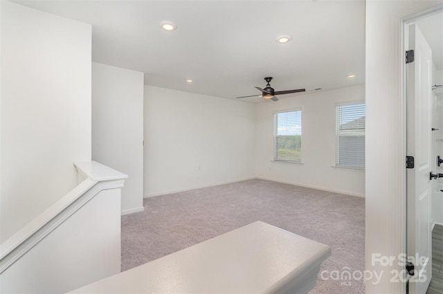 carpeted spare room with baseboards, a ceiling fan, and recessed lighting