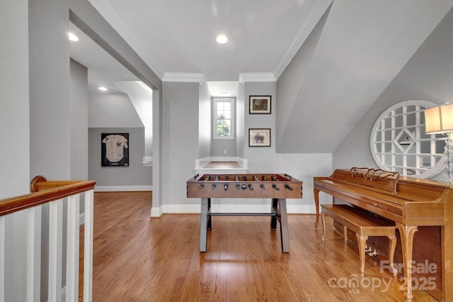 hall featuring baseboards, wood finished floors, and crown molding
