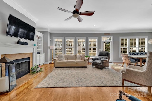 4536 Rustling Woods Dr, Denver, NC 28037 - living area featuring ornamental molding, ceiling fan, a fireplace, recessed lighting, and built in shelves