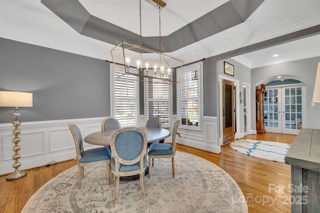 4536 Rustling Woods Dr, Denver, NC 28037 - dining space with a chandelier, french doors, ornamental molding, wood finished floors, and a decorative wall
