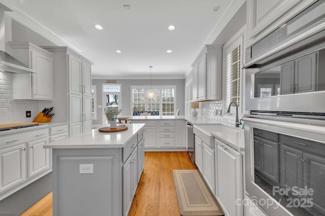 4536 Rustling Woods Dr, Denver, NC 28037 - kitchen featuring wall chimney range hood, appliances with stainless steel finishes, light countertops, a sink, and backsplash