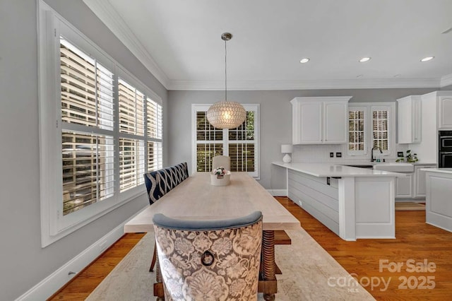 4536 Rustling Woods Dr, Denver, NC 28037 - dining space with light wood-type flooring, ornamental molding, baseboards, and recessed lighting