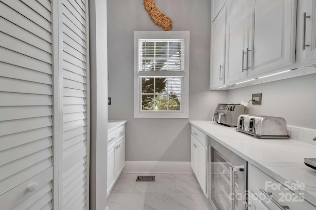 4536 Rustling Woods Dr, Denver, NC 28037 - washroom with wine cooler, light marble finish floors, baseboards, and independent washer and dryer