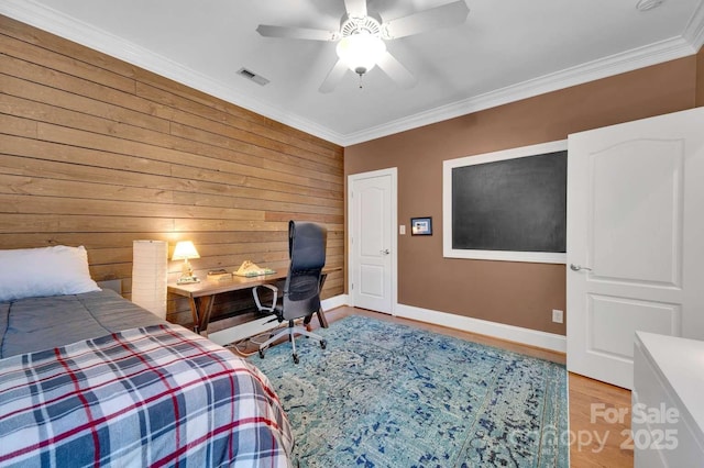 4536 Rustling Woods Dr, Denver, NC 28037 - bedroom with wood walls, light wood-style flooring, crown molding, baseboards, and a ceiling fan