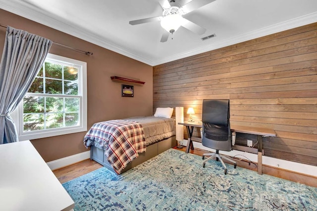 4536 Rustling Woods Dr, Denver, NC 28037 - bedroom with crown molding, baseboards, wooden walls, wood finished floors, and a ceiling fan