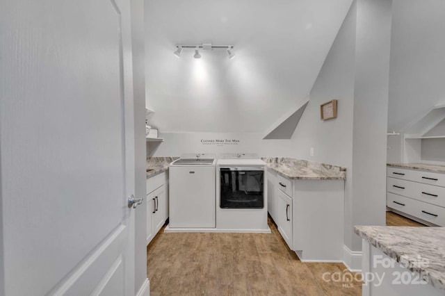 4536 Rustling Woods Dr, Denver, NC 28037 - kitchen featuring separate washer and dryer, white cabinetry, light wood-type flooring, light stone countertops, and vaulted ceiling