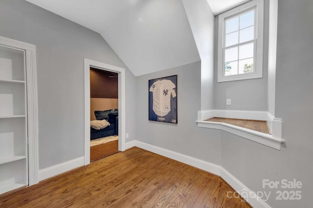 4536 Rustling Woods Dr, Denver, NC 28037 - corridor featuring wood finished floors, vaulted ceiling, and baseboards
