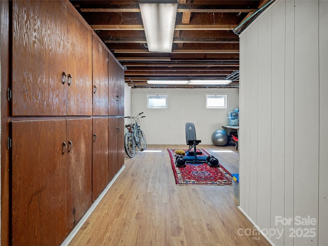 interior space featuring concrete block wall and light wood-type flooring