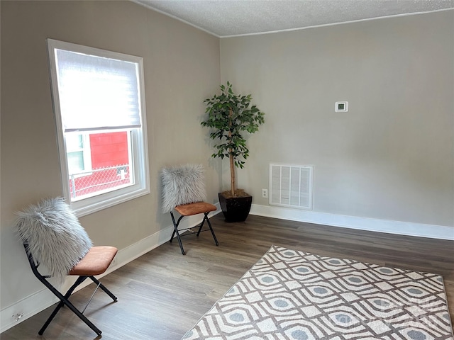507 E Maple Ave, Gastonia, NC 28054 - living area with wood finished floors, baseboards, crown molding, and a textured ceiling