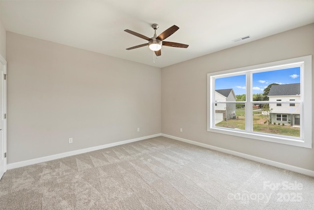 unfurnished room featuring visible vents, a ceiling fan, baseboards, and light carpet