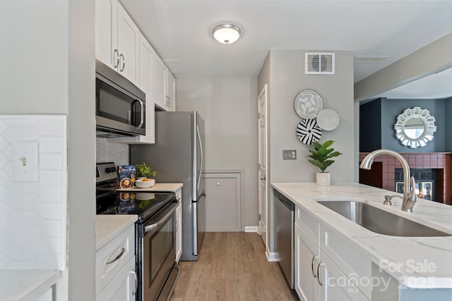419 W 8th St, Charlotte, NC 28202 - kitchen with a sink, stainless steel appliances, tasteful backsplash, and visible vents