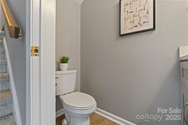 419 W 8th St, Charlotte, NC 28202 - bathroom with toilet, wood finished floors, and baseboards