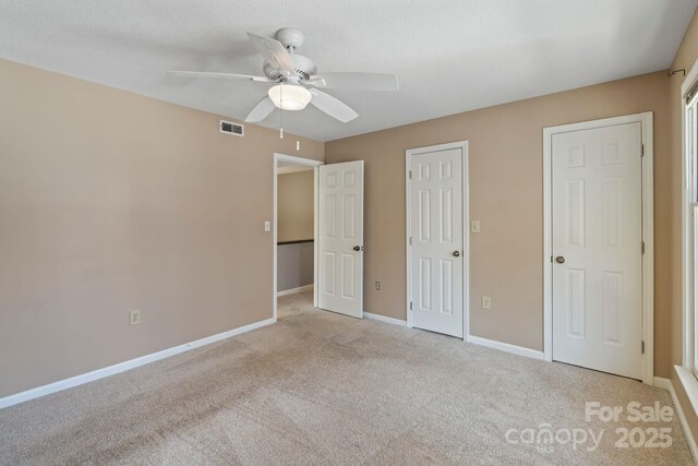 419 W 8th St, Charlotte, NC 28202 - unfurnished bedroom featuring visible vents, a ceiling fan, carpet, and baseboards