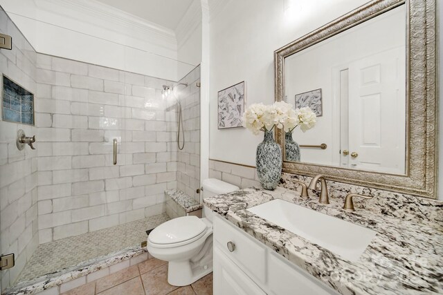 bathroom featuring vanity, ornamental molding, a stall shower, and toilet